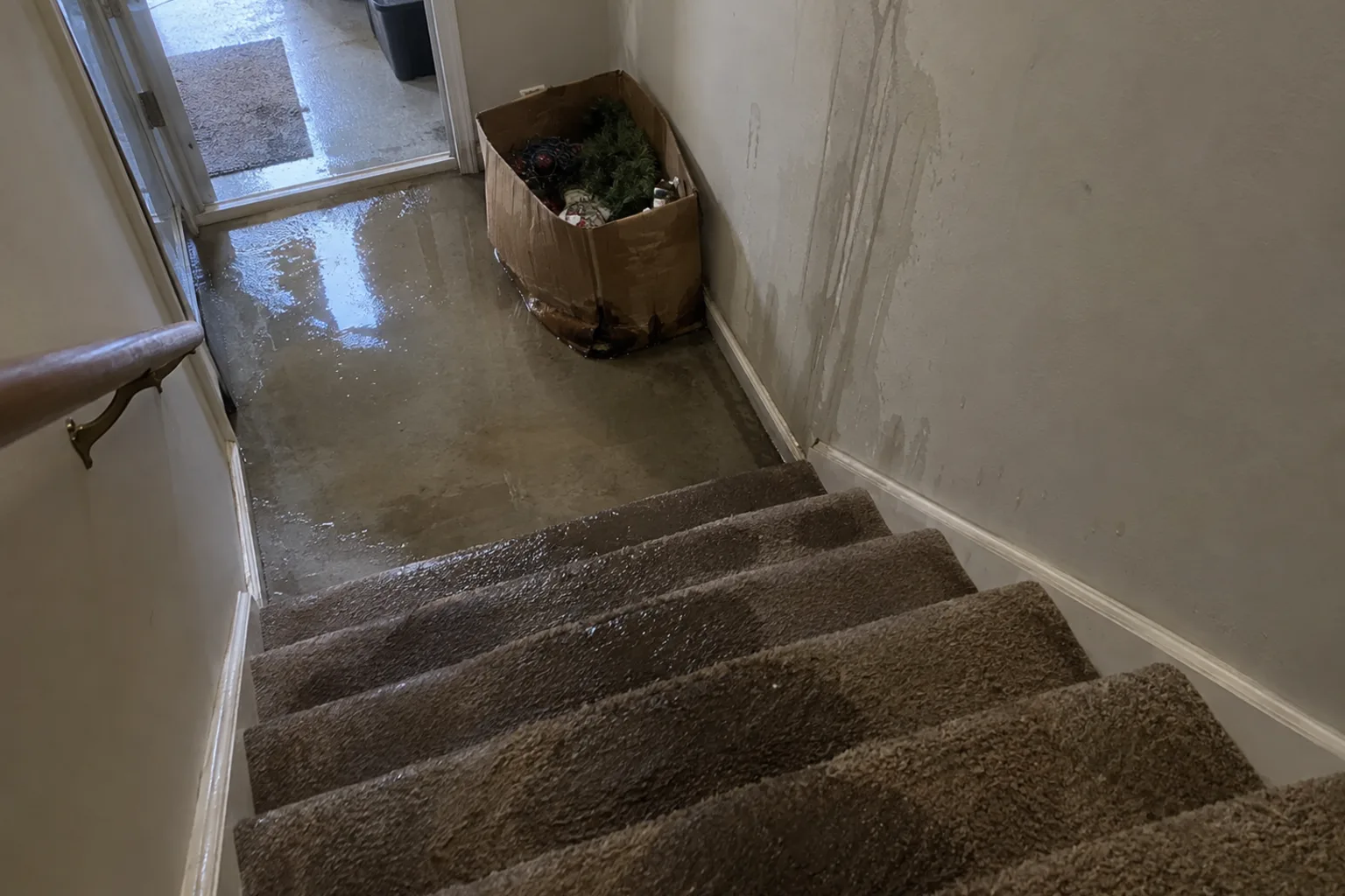 Technician using commercial water extraction and drying equipment in a Columbus home